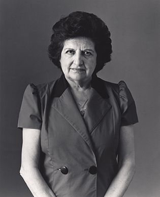 waist length black and white photo of an older woman with dark hair