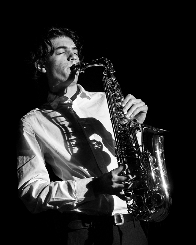 young man playing a saxaphone