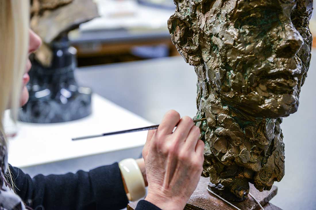 Conservator working on a piece of sculpture
