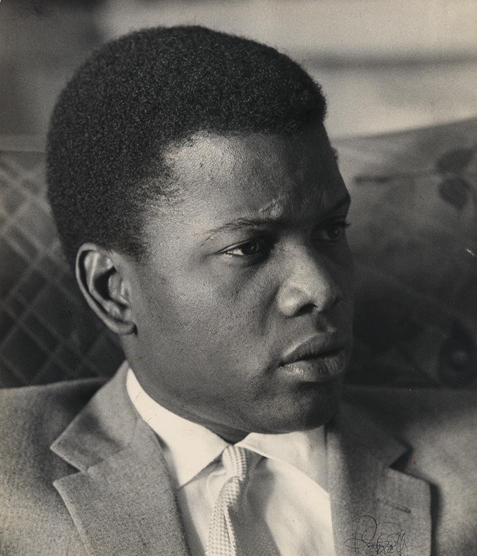 black and white photograph, head shot of a young Black man, facing right