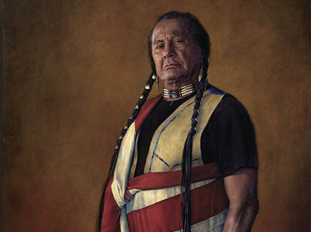 Native American man wrapped in an American flag