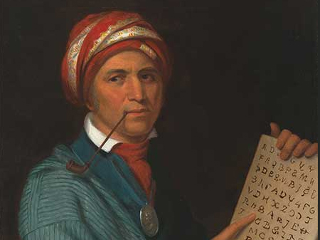 Native American man in a turban with a tablet