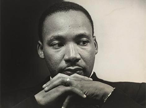 African American man with his chin resting on his crossed hands