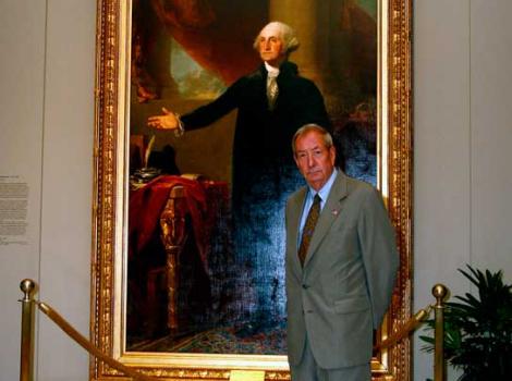 Man in front of a portrait