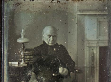 Old photograph of old man looking at the camera