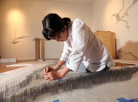young woman working on an architectural model