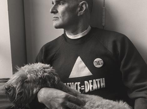man in a sweatshirt holding a dog