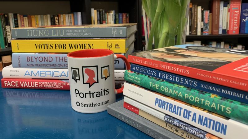 Desk with colorful books and a mug