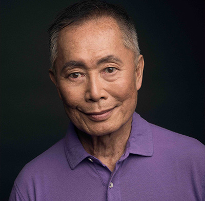 bust length photo of an Asian man in a purple shirt