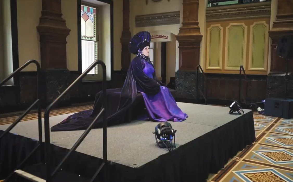 woman in a purple queen-like costume