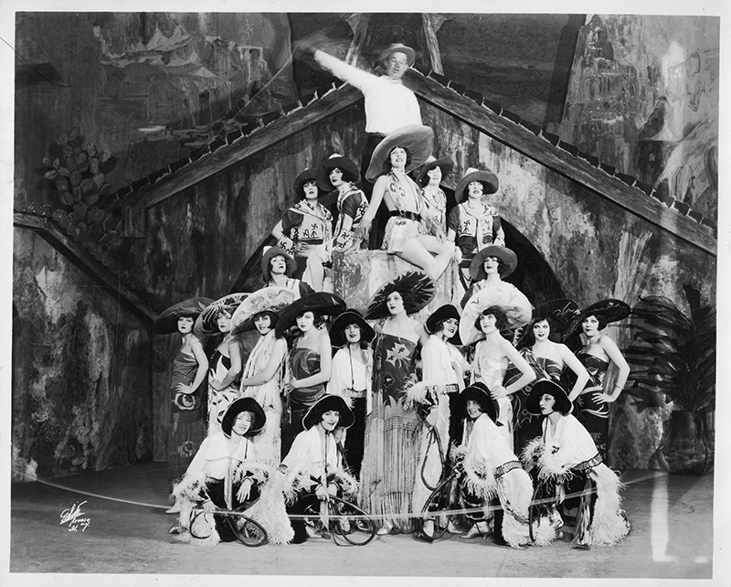 large group of dancers arranged in a pyramid