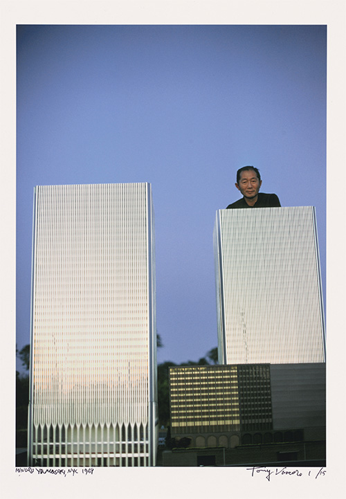 man standing with models of skyscrapers